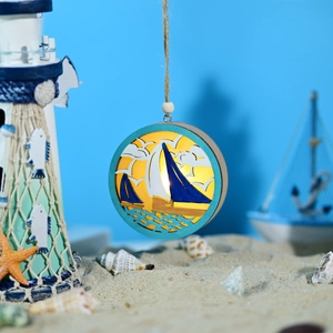 Detailed nautical wooden LED light with sailboat wood carving and warm glow