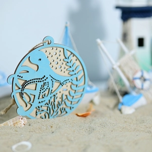 Detailed laser-cut octopus wooden ornament resting on sand with nautical decorations