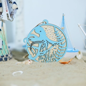Blue wooden octopus hanging ornament with starfish and shells in nautical beach theme