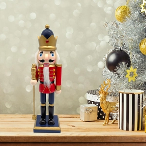Close-up of a 25.5cm wooden Nutcracker soldier with a golden crown and scepter