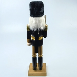 Rear view of black and gold nutcracker soldier with faux fur hat and white long fiber hair