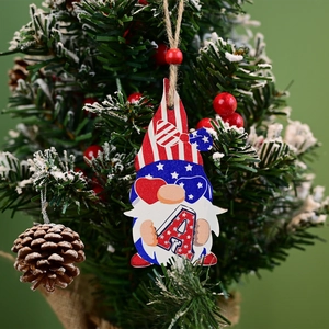 Detail of wooden gnome pendant with stars and stripes hat on a festive tree branch
