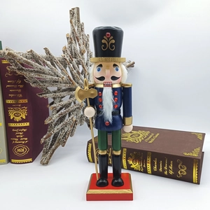 Classic nutcracker soldier ornament with blue uniform and gold axe on a festive tabletop