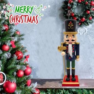 Classic wooden nutcracker soldier standing on a red base with Christmas tree background