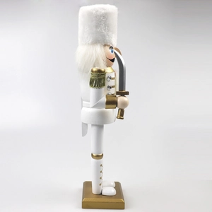 Detail of a 30cm white and gold nutcracker king with plush hat and gold tassels