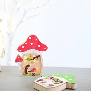 Detail of wooden mushroom lamp with LED forest carving featuring hedgehog and leaves