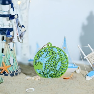 Detail of wooden sea horse pendant with laser-cut seaweed and nautical decorations