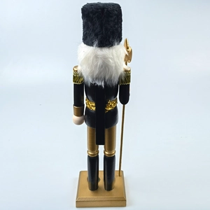 Rear view of black and gold Nutcracker soldier with white faux fur beard and gold epaulettes