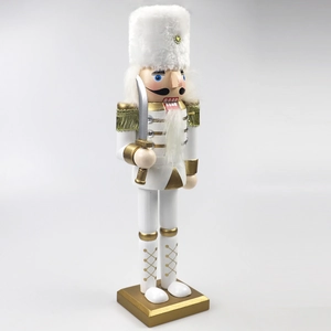 Detailed close-up of a 30cm white and gold wooden nutcracker soldier with a golden sword