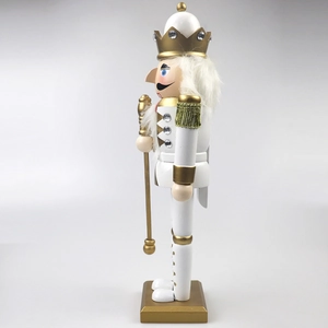 Detail of a 30cm white and gold nutcracker king statue with faux gems and scepter