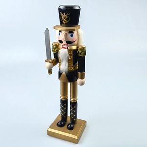 Detailed close-up of a classic black and gold wooden nutcracker soldier with a sword
