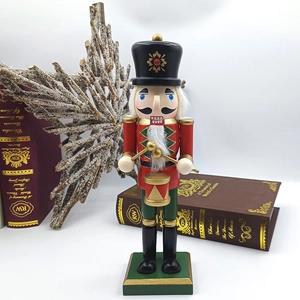 Detail of wooden nutcracker drummer with drum and sticks for Christmas home decor