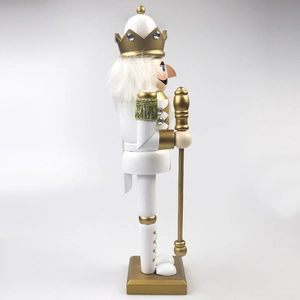 Detail of white and gold King Nutcracker soldier featuring a royal scepter and crown