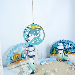 Detail of wooden whale wall plaque with nautical beach theme and rope hanger for home