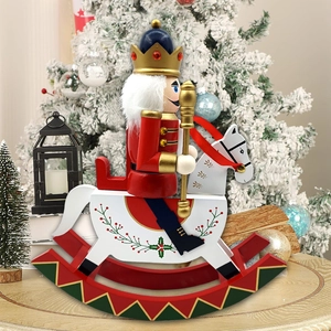 Close-up of wooden nutcracker soldier on rocking horse with festive crown and golden scepter
