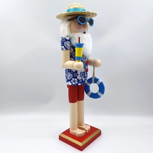 Side view of Hawaiian Nutcracker in blue floral shirt with sunglasses and straw hat