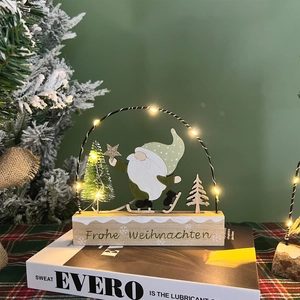 Wooden Christmas gnome light with LED arch and warm tree on a festive table