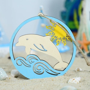Close-up of laser-cut wooden dolphin wall decor featuring sun and waves on a sandy beach