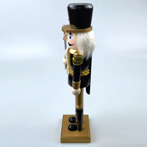 Close-up of black and gold nutcracker soldier with tassels and white faux fur beard