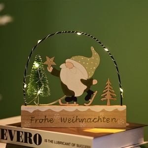 Detail of wooden Christmas gnome ornament with warm LED light and frosted pine tree