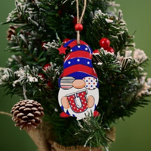 Detail of wooden gnome ornament with USA Independence Day theme hanging on a festive tree branch