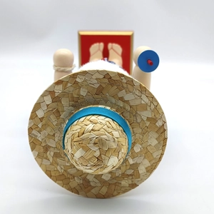 Detailed top view of a wooden Hawaiian pirate figure featuring a straw hat and flip-flops
