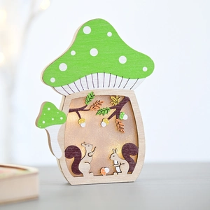 Close-up of wooden mushroom lamp with warm LED lights and carved squirrel forest detail