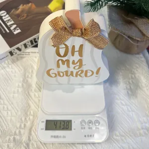 Detailed view of pumpkin wood decor with burlap bow showing weight on digital scale