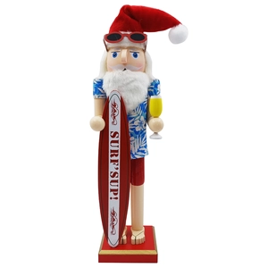 Detail of wooden Hawaiian Nutcracker Santa holding a red surfboard and summer drink