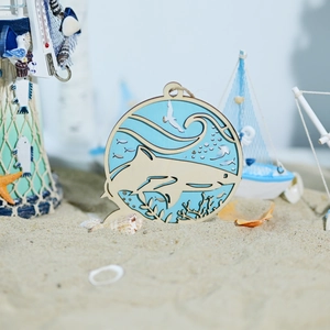 Detail of 3D layered wooden shark ornament featuring sea waves and coral on sand