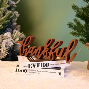 Macro detail of brown wooden Thankful letter sign on decorative books for home decor