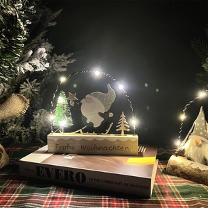 Detail of wooden Christmas gnome night light with warm LED lights and Frohe Weihnachten text