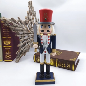 Detail of 25.5cm wooden Nutcracker soldier with red hat and sword on white background