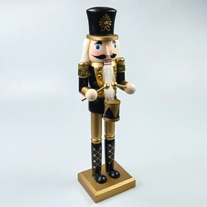 Detail of drumming Nutcracker soldier with black and gold paint and faux hair trim
