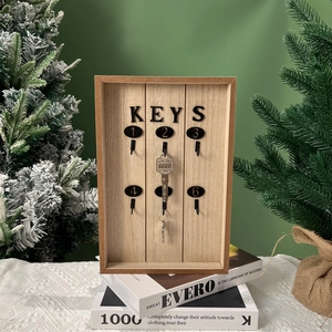 Detail of wooden key organizer box with six metal hooks and black lettered KEYS sign