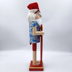 Side view of Hawaiian beach Santa nutcracker with red surfboard and floral shirt
