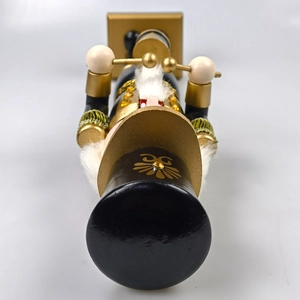 Detail of black and gold Nutcracker soldier with sequins and faux fur beard trim
