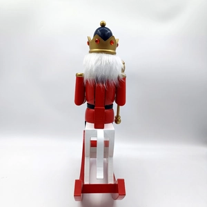 Rear view of 30cm wooden nutcracker king on rocking horse with moving lever detail
