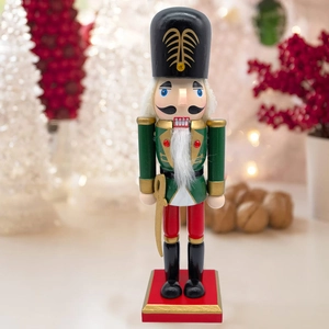 Detail of traditional wooden Nutcracker soldier with gold accents and festive holiday background
