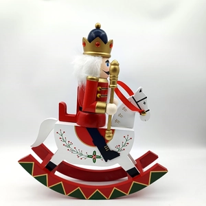 Detail of wooden nutcracker soldier on rocking horse with hand-painted festive details