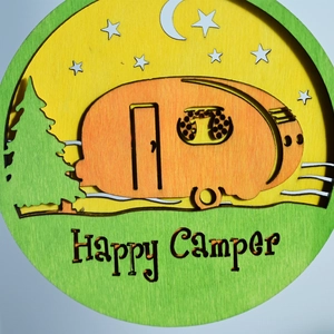 Detail of wooden Happy Camper wall art with a colorful van, pine tree and starry sky