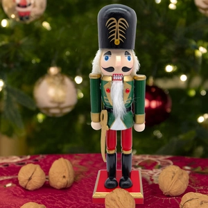 Detail of 25.5cm wooden Nutcracker soldier with green uniform and gold sword on red base