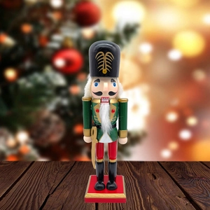 Detailed view of a classic nutcracker soldier on a wooden desk with festive bokeh background
