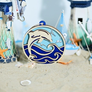 Macro detail of nautical wooden wall art featuring 3D carved dolphins and ocean waves