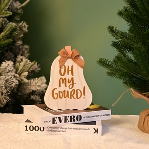 Detail of wooden pumpkin decor with burlap bow and Oh My Gourd text on books
