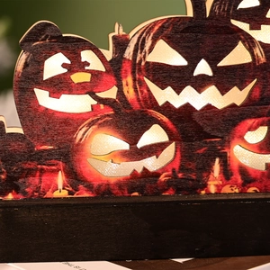Halloween wooden pumpkin LED light decoration with glowing carvings and a black base