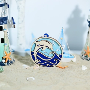 Detail of layered wooden ocean wall art with dolphins and waves in nautical beach setting