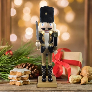 Classic black and gold Nutcracker soldier ornament in a festive Christmas holiday setting