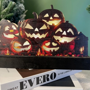 Illuminated Halloween wooden LED pumpkin lamp decor with warm light on books