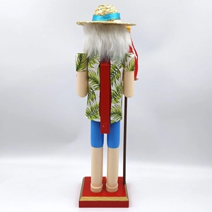 Rear view of Hawaiian Nutcracker in palm leaf shirt and straw hat on red wooden base